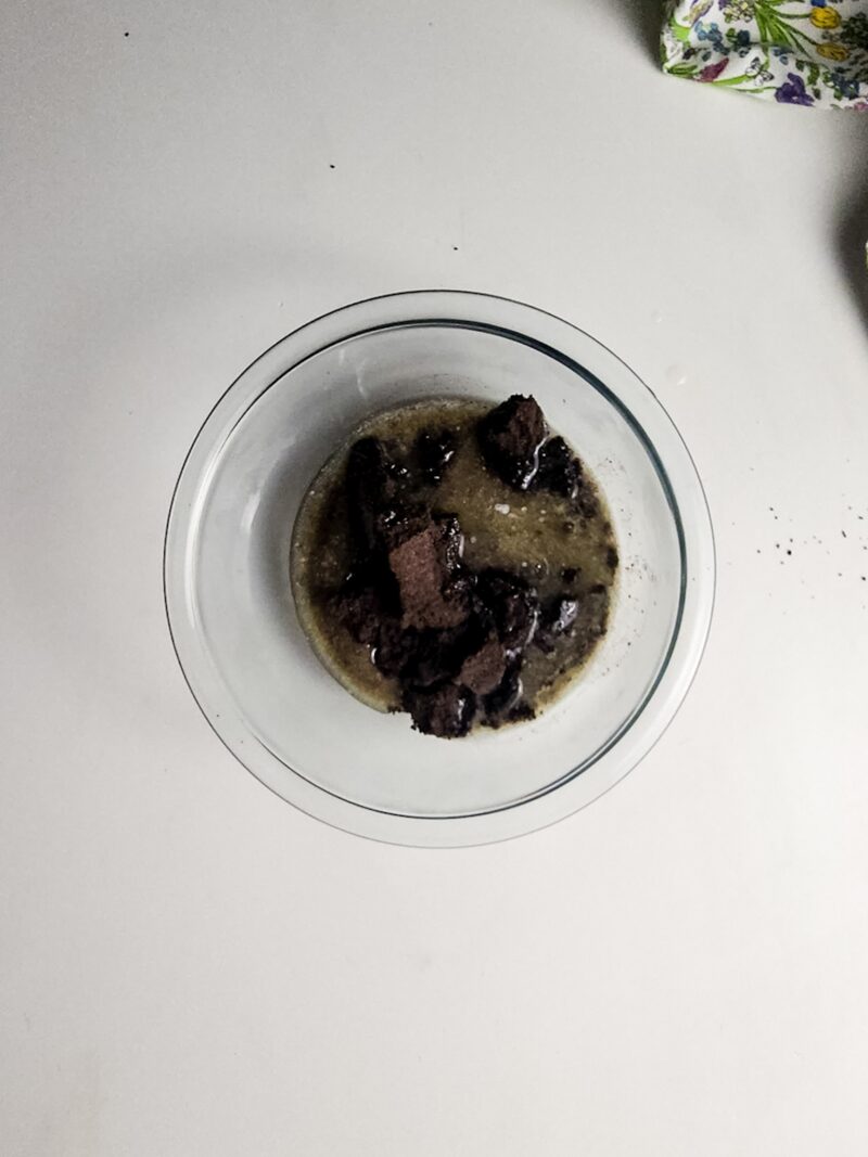 Mixing the crushed cookies with butter