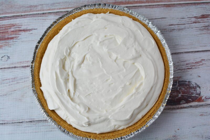 Pour the cream cheese filling into the graham cracker crust
