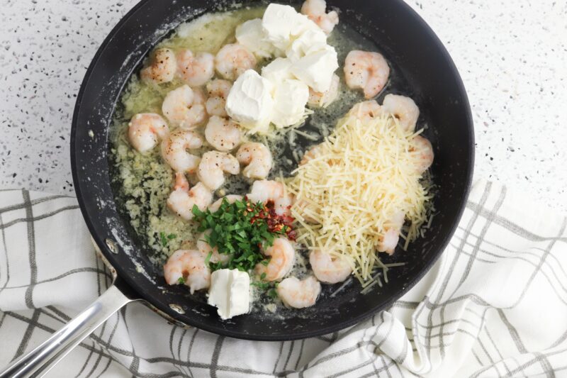 Stirring in the creamy ingredients to make shrimp mixture