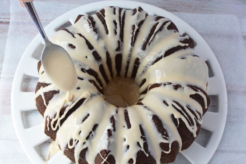 Spooning the glaze over the top of the cake