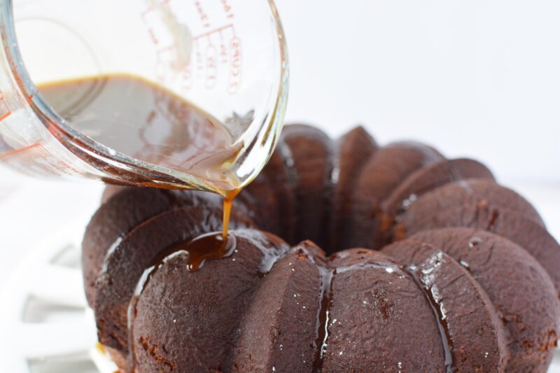 Pouring the kahlua glaze over the top of the cake