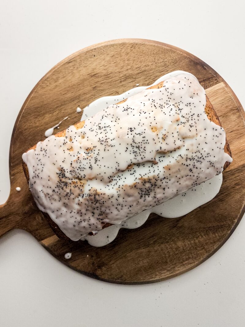 Adding the glaze and poppyseeds on top