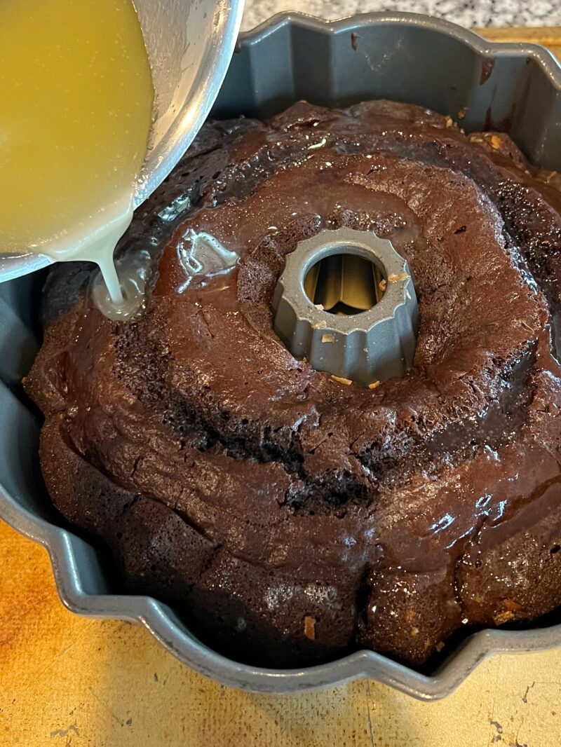 Pouring glaze over the top of the cake