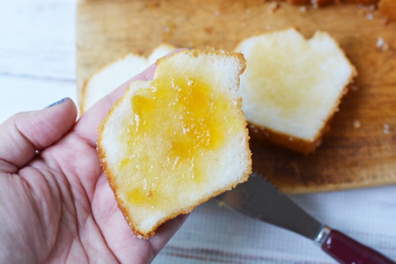 spreading the jam over the cake
