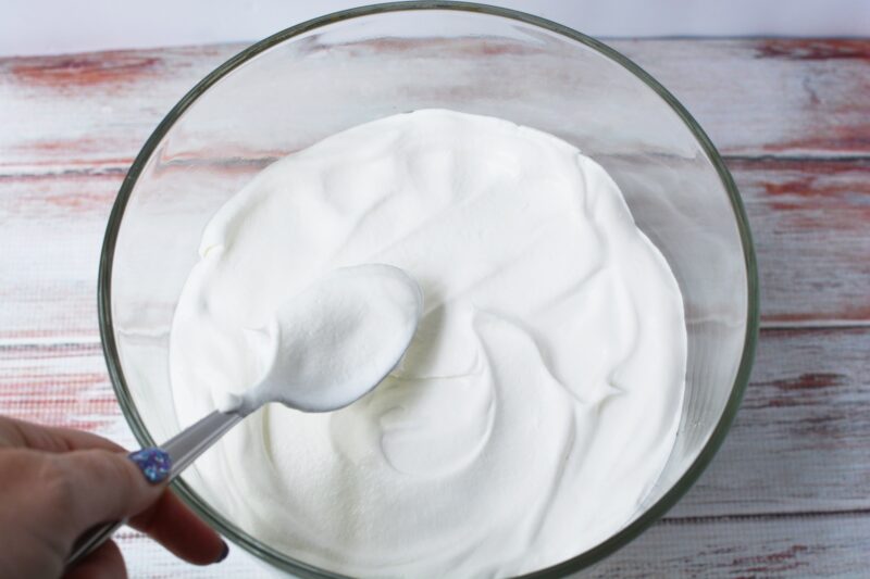 spreading the Cool Whip on top of the pastry cream