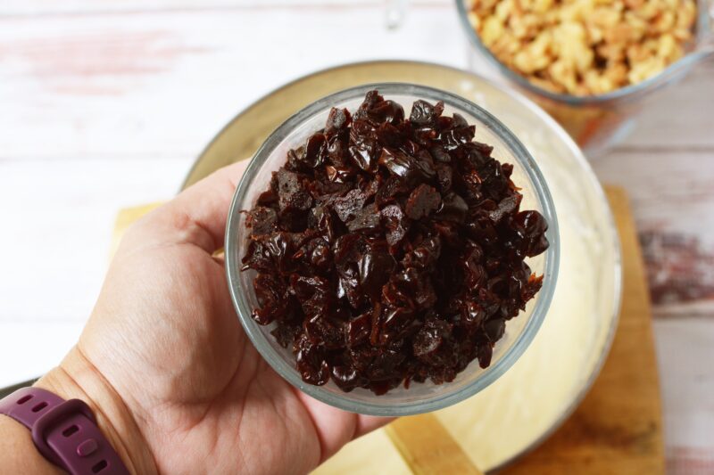 Adding the dried cranberries to the fudge