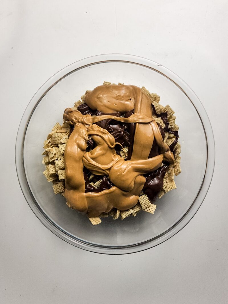 Pouring the milk chocolate and peanut butter over the cereal