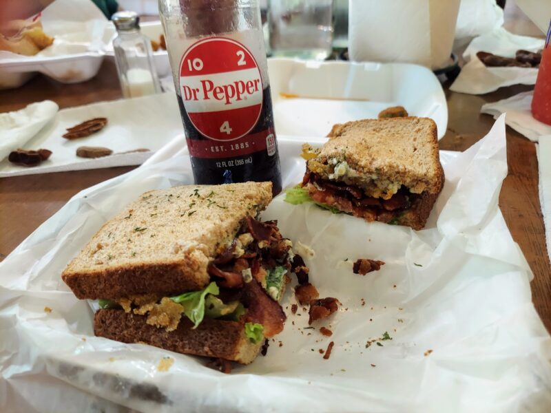 A fully stuffed fried green tomato sandwich and a Dr. Pepper in a bottle from The Tomato Place in Vicksburg, Mississippi. 