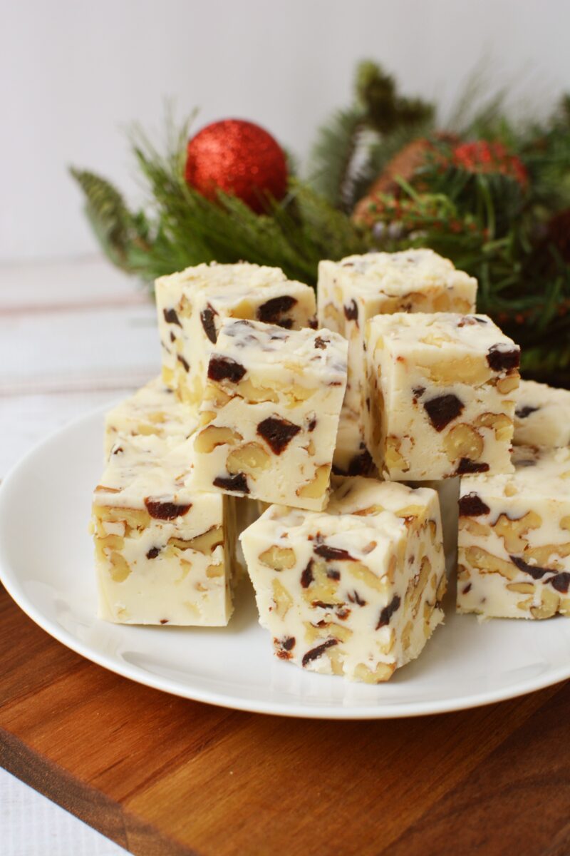 This White Chocolate Cranberry Walnut Fudge recipe is so festive! It's speckled with dried cranberries and chopped walnuts. Make a batch to give away and freeze the rest. #Fudge #HomemadeFudge #ChristmasCandy #ChristmasFudge #CranberryRecipe #HomemadeHolidayGift White Chocolate Cranberry Walnut Fudge Recipe